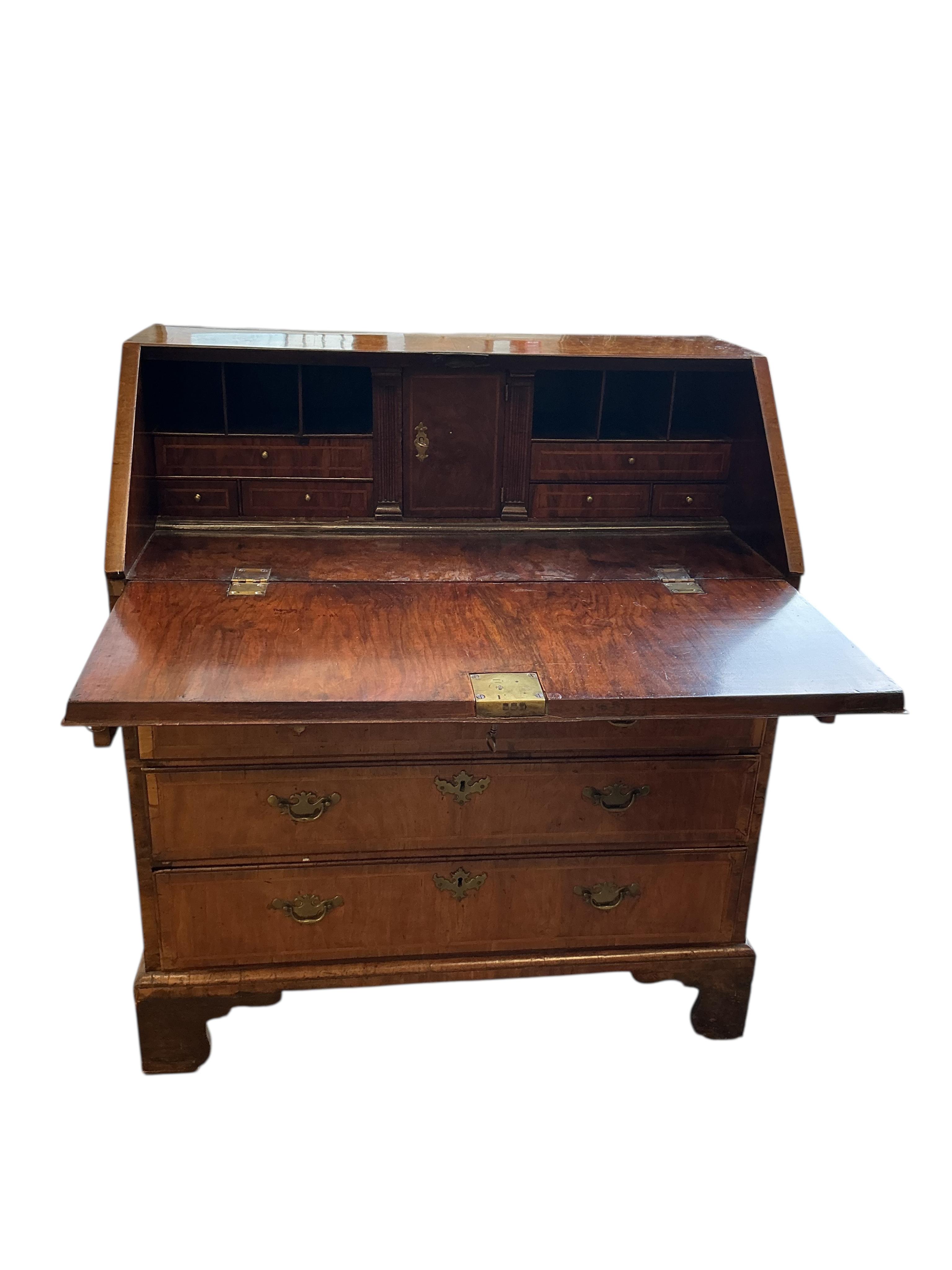 A George I feather banded walnut bureau, width 95cm, depth 52cm, height 106cm
